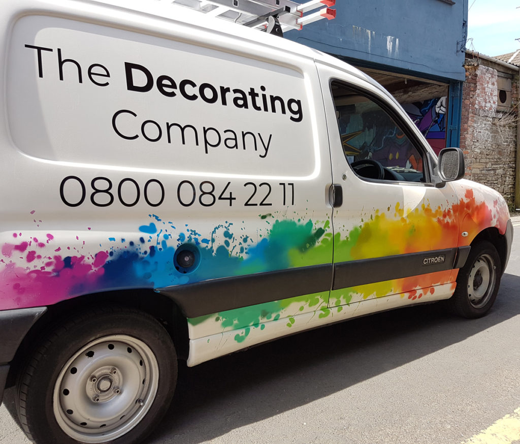 Vinyl lettering and painting on the side of the van of The Decorating Company