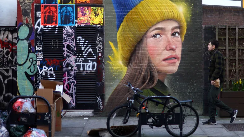 Mural of a girl wearing a Beanie with the Ukrainian flag colours - In London by artist WOSKerski, in London 